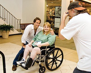 CELEBRITY SHOT: "Days of Our Lives" actor Shawn Christian poses with fan Judith McNear of Niles at Eastwood Field while McNear's friend Charles Benchia of Warren snaps a picture.