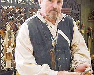 HANDIWORK: Art Blair of Girard uses a rasp to shape many of his wooden folk art sculptures. Shaker Festival, Beaver, OH Sunday, August 10, 2008.