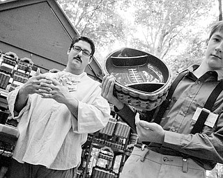 Joe Nelson, left, with his son Riley, 13, explain how some baskets are weaved to carry more load than others. Riley takes full credit, however, for the football idea. Shaker Craft Festival in Beaver Sunday, August 10, 2008. Daniel C. Britt.