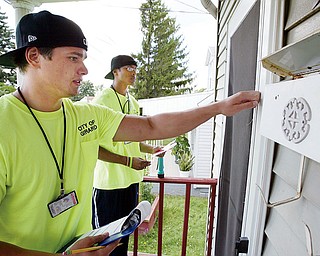 DOOR TO DOOR: Girard meter readers Ben Belcik, left, and Brien Golden try to reach the occupant of this Ohio Avenue home. Like with most attempts by readers in the city, it was unsuccessful Monday. No one was home.