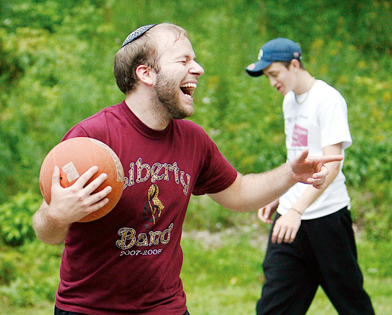 FUN GAME: Weisberg shares a laugh with friends while playing the game. In the background is Stoyak.