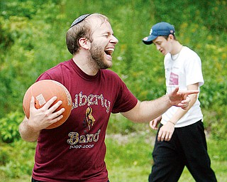 FUN GAME: Weisberg shares a laugh with friends while playing the game. In the background is Stoyak.