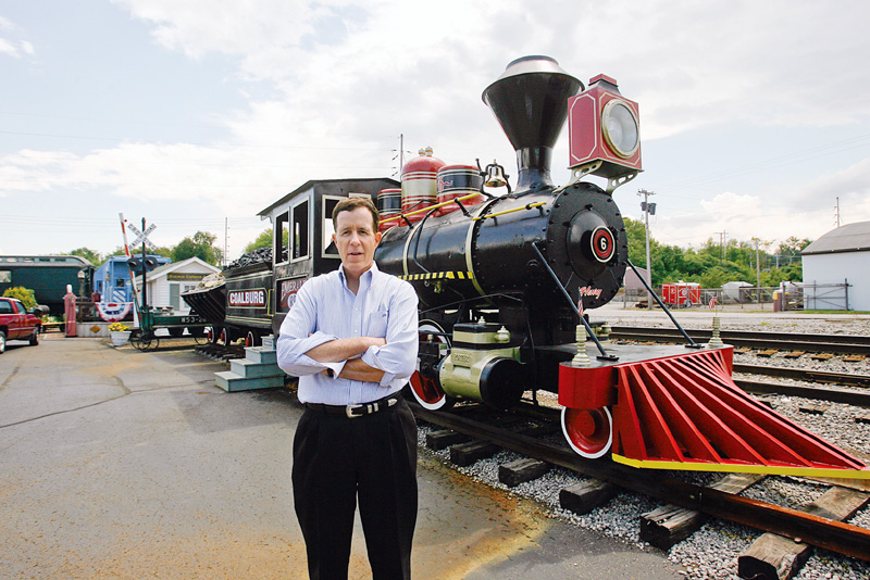ENGINE PRESERVED: hubbard businessman J.P. Marsh stands near the 1910 Porter steam locomotive that he had reconditioned. The engine was used in carbon limestone mining in the Youngstown area until the 1960s. It's on display at the rear of the Emeral Diner in Hubbard.