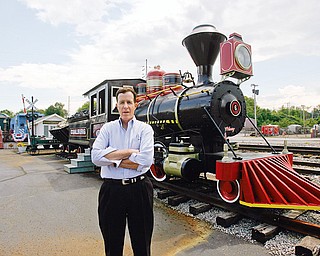 ENGINE PRESERVED: hubbard businessman J.P. Marsh stands near the 1910 Porter steam locomotive that he had reconditioned. The engine was used in carbon limestone mining in the Youngstown area until the 1960s. It's on display at the rear of the Emeral Diner in Hubbard.