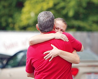 SORROWFUL HUG - Two patrons hug each other as police investigate a roped off area next to Freddie's Diner. One person was shot to death and another seriously wounded Tuesday during a robbery at a North Park Avenue restaurant and social club. Police are looking for at least one black man who went into Freddie’s Diner, 1125 North Park Ave., to rob it shortly before 9 a.m.