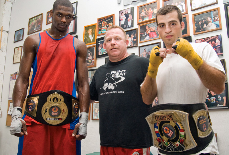 WINNERS: Wesley Triplett, 22, of Youngstown, left, poses with Kelly Pavlik's trainer Jack Loew, center, and fellow amateur champion Chris Hazimihalis, 23, also of Youngstown at the Southside Boxing Club. The boxers won titles last weekend.