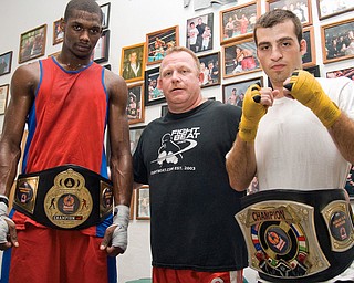 WINNERS: Wesley Triplett, 22, of Youngstown, left, poses with Kelly Pavlik's trainer Jack Loew, center, and fellow amateur champion Chris Hazimihalis, 23, also of Youngstown at the Southside Boxing Club. The boxers won titles last weekend.