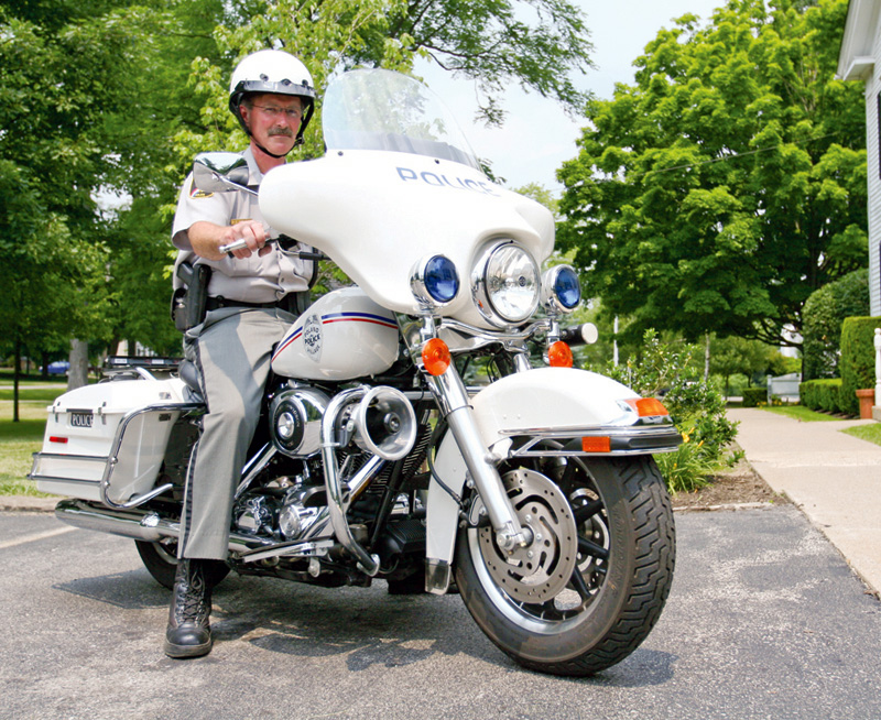 SMART SOLUTION: Russ Beatty, Poland Village police chief, rides one of the department's two Harley Davidson motorcycles, which were purchased with seized drug money. Some police agencies are using motorcycles and bicyclees to save money and gain an advantage over criminals. Two-wheeled options save fuel, and the initial equipment costs are lower than equipping a police car.