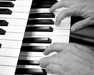 HANDIWORK: The hands of Thomas Pavlechko may be seen as a hand double for actor Brad Pitt in a movie to be released next year. The former Mahoning Valley residents is now an accomplished musician.