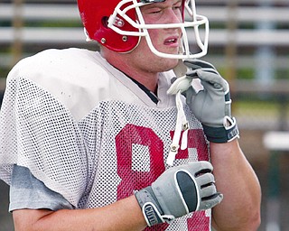 READY FOR POSITION ADJUSTMENT: Youngstown State tight end Derrick bush adjusts his helmet during practice this week at Stambaugh Stadium. YSU's tight ends will line up all over the field this season and Bush is excited about it.