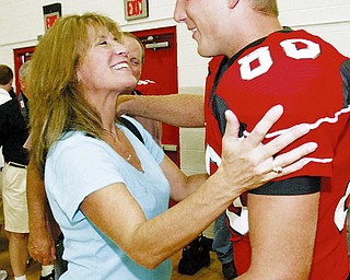 Tight end Patrick bellish dets a hug from his mother, Lynne, of Canfield.