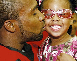 In this photo from Youngstown State's annual football media day in 2008, Tyler Griffin kisses his daughter.