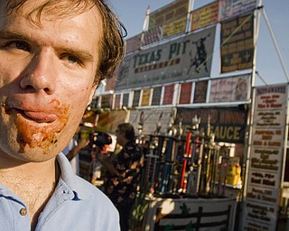 Sean Boughner, 22, of Boardman enjoying a rack of ribs at the Miller Lite National Rib Cook-Off Saturday, August 16, 2008 outside the Chevy Centre. Daniel C. Britt.