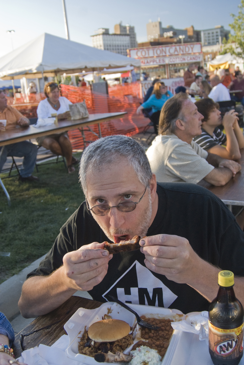 John Busco enjoys some Mojo hickory ribs at the rib fest Saturday, August 16, 2008. Daniel C. Britt.