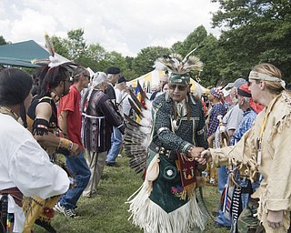 Shayne Norris of Newark shakes hands with a fan after finishing his tribal dance.