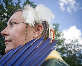 Michele Hite of Plain City poses with colored feathers.