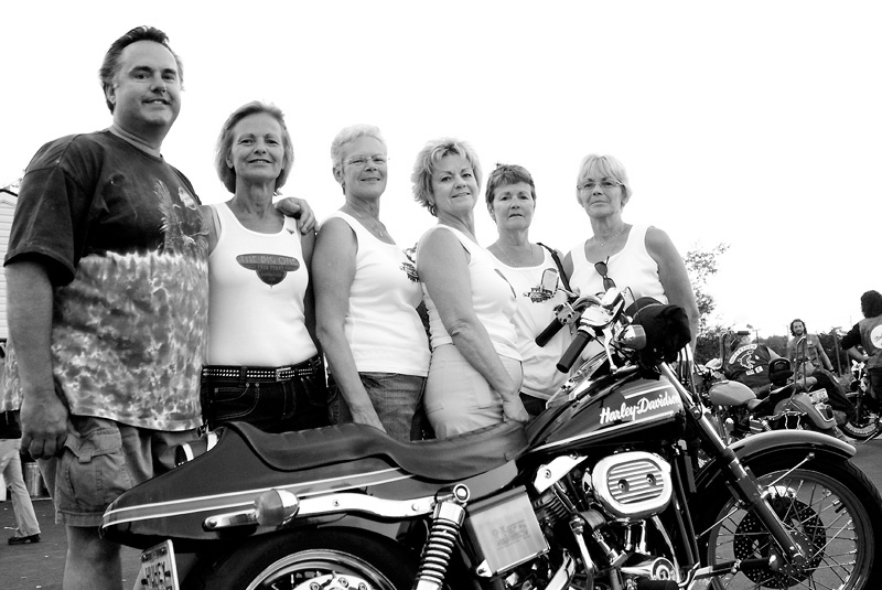 PROUD OF THEIR FATHER: Six of the seven of Fred Perry's children, from left, Troy Perry, Candy Estok, Mary Jane Hively, Nancy Martucci, Gail Figansksy and Pam Lewis, show off their father's 1974 Harrley-Davidson Superflide during the Fred Perry Benefit Motorcycle Run for Kids in Austintown.