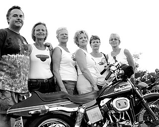 PROUD OF THEIR FATHER: Six of the seven of Fred Perry's children, from left, Troy Perry, Candy Estok, Mary Jane Hively, Nancy Martucci, Gail Figansksy and Pam Lewis, show off their father's 1974 Harrley-Davidson Superflide during the Fred Perry Benefit Motorcycle Run for Kids in Austintown.