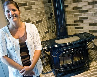 HEATING THINGS UP: Lisa O’Connell keeps her family warm in the winter with a wood-burning stove. Besides heating their home in Berlin Center, her family uses the stove to cook and even dry their gloves in the winter.