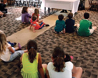 The audience watches as Sara Churchill puts on a small performance to entertain them.
