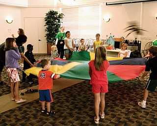 Children play with the parachute activity at Austintown Library. (ok)
