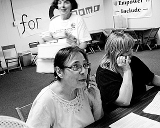 Volunteers Shirley Matyi of Austintown, left, works with Volunteer Darlene White of Austintown soliciting support for Barack Obama over the telephone at the Democratic candidate's new office on Market Street. Thursday, August 22, 2008.