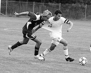 MOONEY - JACKSON - (16) Evan McCreary grabs the shirt of (10) James Simon of Mooney during their game Thursday night.