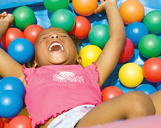Aiyna Moore, 3, of Youngstown in the ballpit at Community Day at the Rockford Village in Youngstown Saturday, August 23, 2008. Daniel C. Britt.