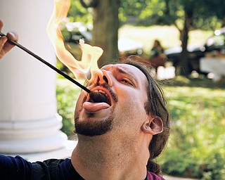 Travis Fessler, 35, plays with fire at the North side farmers market, Saturday, August 23, 2008. Daniel C. Britt.