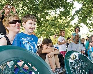 Jan Crews of Youngstown, in sunglasses, and her grandchildren, Boston Clark, 7, of Youngstown and Ridley Clark, 5, of Youngstown are among the crowd assembled for the Pickle Bros. side show at the North side farmers market, Saturday, August 23, 2008.