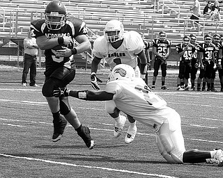 MCDONALD - YOUNGSTOWN CHRISTIAN - (9) Alex Sampson of McDonald score as (21) Carlen Sims and (1) Ryan Davenport can't make the stop Saturday afternoon in Canfield. - Special to The Vindicator/Nick Mays