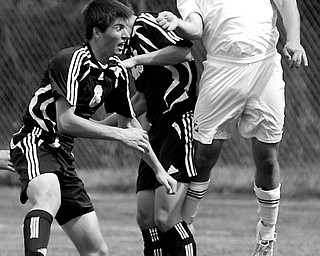 USING HIS HEAD: Robby Fox (8) defends Mooney's goal against Perrysburg's Matt Smith (6) and Karter Sell during the first half of Saturday's game at Valley Sports in Struthers. Mooney won, 301.