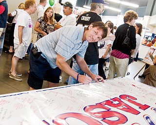 Former SteelHounds coach Kevin Kaminski signs the banner that will serve as Baird's Birthday card at the Jason Baird Fundraiser Sunday, August 24, 2008 at the Chevy Centre.