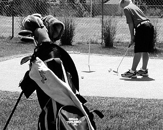Brian Terlesky, 8, of Boardman practices putting at his home. Brain has been playing golf since he was 4-years-old and dreams of playing with Tiger Woods one day.