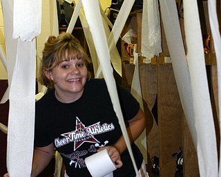 "Senior Tizzy Baytos helps decorate the football locker room for the game."