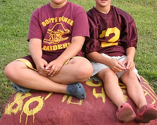 "Mario and Neil Buzzacco wait for their brother,football player David,
to enter the field at the South Range game Friday night."