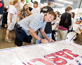 Coach Kevin Kaminski signs the banner that will serve as Baird's Birthday card at the Jason Baird Fundraiser Sunday, August 24, 2008 at the Chevrolet Centre.