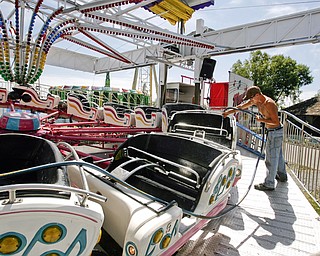 DJ Winland of Wintersville cleans one of Bates Brothers Amusement rides