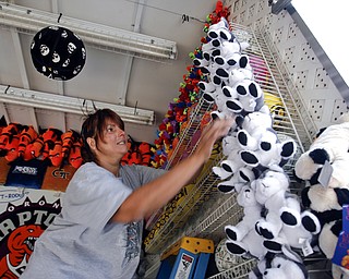 Alice Durst of Akron arranges stuffed animals at the basketball hoop game.