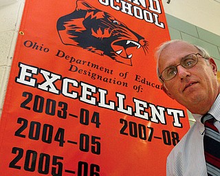 Howland High School principal Frank Thomas with a banner in the hallway of the school.