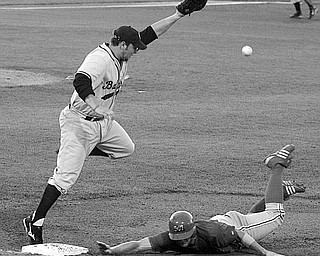 SCRAPPERS - (25) Robbie Alcombrack looses the ball as (12) Shane Peterson gets back to the bag during their game Tuesday night.