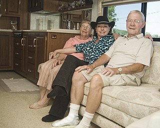 Bill Ward and his wife Louise of Freeport, Pa., flank daughter Victoria Miller of Salt Lake City, Utah. The trio is camped at the Canfield Fair in a 37 ft. Tasko Horizon complete with a kitchen, master bedroom, full shower and bathroom. Canfield Fair, Saturday, August 30, 2008. Daniel C. Britt. 