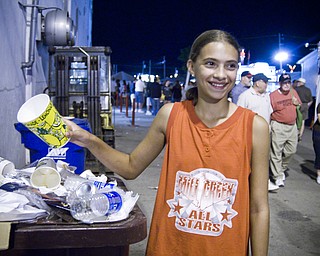 Megan Sefehik, 12, of Austintown drops her trash into an overflowing bin at the Canfield Fair Sunday August 31, 2008. Daniel C. Britt.