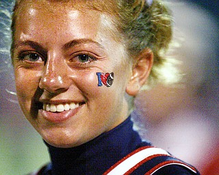 TRUE COLORS: Melissa Lynn, an Austintown Fitch junior who performs double duty as a cheerleader and band member, shows off her school pride during the Falcons' home game against East.