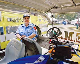 FAIR FORCE: Karen Davis of Coitsville, a firefighter, nurse and emergency medical responder, said the team at the Canfield Fair has a cart equipped with a medical bed, automated external defibrillator and portable water tanks, as well as full fire gear.