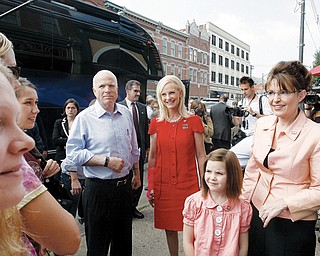 PITTSBURGH STOP: Republican presidential candidate John McCin of Arizona talks with voters outside Tom's Diner, along with his wife, Cindy, and his running mate, Alaska Gov. Sarah Palin, right, in Pittsburgh. With the group Saturday was Palin's daughter, Piper.