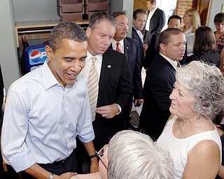 EAST AND GREET: Democratic presidential nominee Barack Obama greets patrons at the Yankee Kitchen Family Restaraunt in Boardman. The 50 or so people eating breakfast there early Saturday got to see Obama and Joe Biden, his vice presidential running mate, along with their wives.