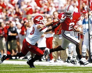 HARDING CONNECTION: Ohio State running back Daniel Herron (2) pushes away Youngstown State defender Jarvis Richards during Saturday's game in Columbus.