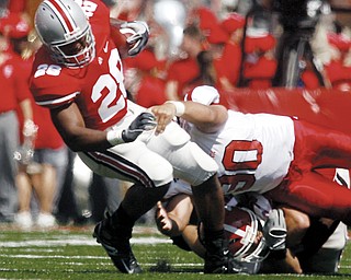 HEISMAN HOPEFUL HURT: Ohio State running back Chris "Beanie" Wells (28) gets pulled down by Youngstown State defender Ben Lane during the first quarter of the Buckeyes' romp in Columbus. Wells injured his leg in the third quarter.