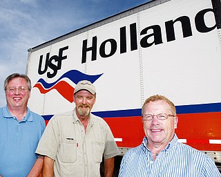 A GOOD DEED INDEED: USF Holland Trucking Co. employees, from left, Bob Praft, operations supervisor; Gary Speelman, driver; and Jim Chandler, assistant supervisor, were involved in helping return lost jewelry to George and Karen Scull of Kirsey, Pa.